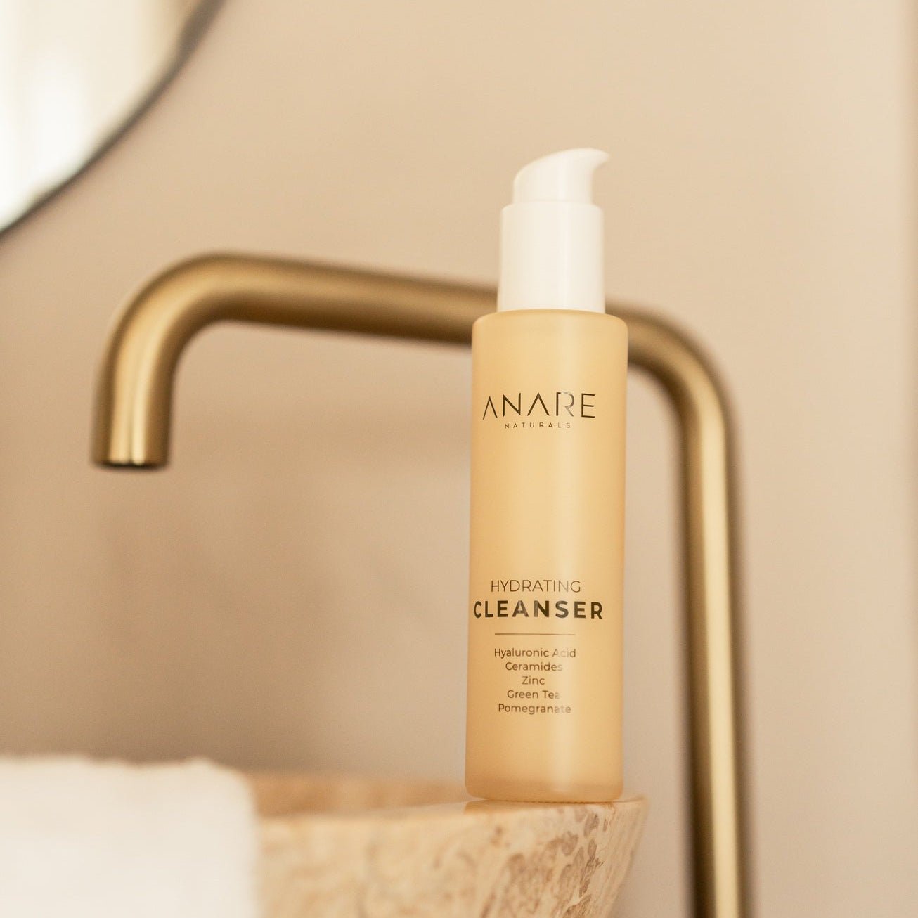 Anare Skincare cleanser bottle on a bathroom counter with a blurred background
