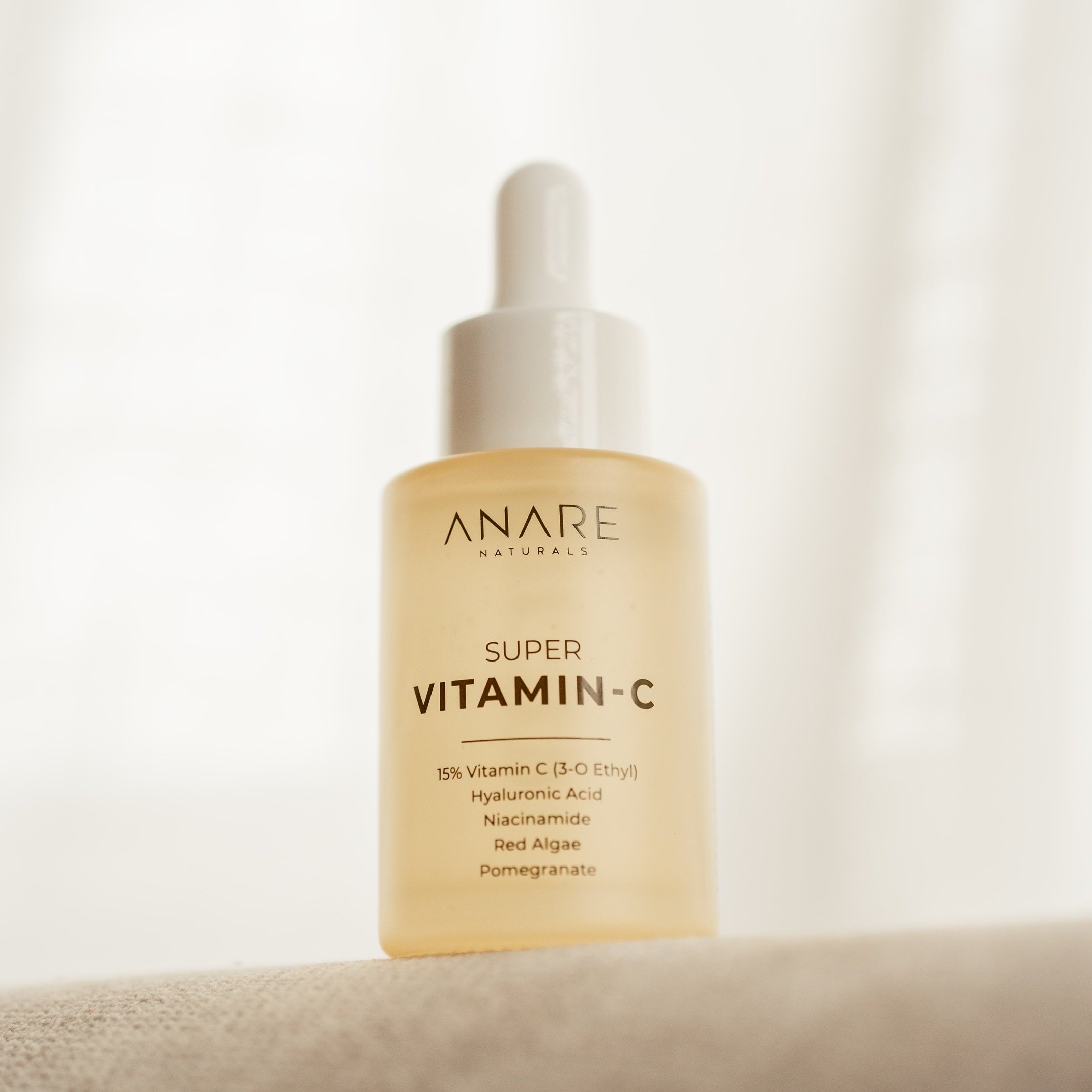 Anare Naturals 15% Super Vitamin C serum bottle on a light background