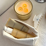 Candle and deep cleanse bundle from Anare Naturals skincare  on a textured surface
